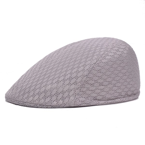 Detail view of grey mesh newsboy cap showing breathable fabric and side profile design