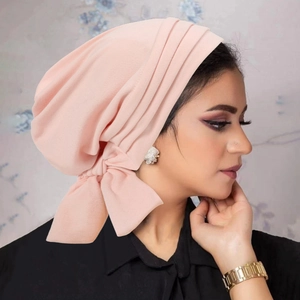 Close-up of pink velvet turban hat for women featuring a stylish side bow detail