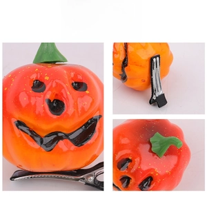 Detailed views of Halloween pumpkin hair clip showing the resin jack-o-lantern and metal grip