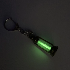 Vintage kerosene lamp hourglass necklace with glowing green luminescence and bronze metal finish