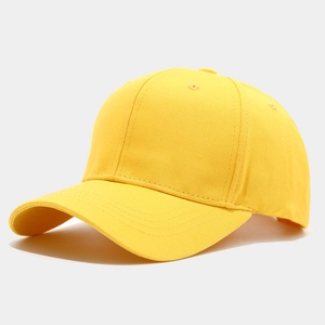 Detailed texture of bright yellow cotton canvas six-panel baseball cap with curved brim