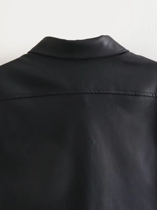 Close-up of black leather top showing collar detail and fine stitching craftsmanship