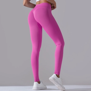 Detail of high-waisted hot pink yoga pants showing peach lift seam and seamless knit texture
