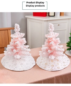 Detailed view of plush white mini Christmas tree skirt with golden star patterns