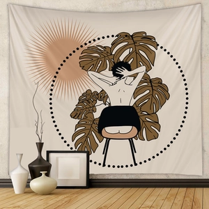 Detail of bohemian wall tapestry featuring minimalist line art and monstera leaf patterns