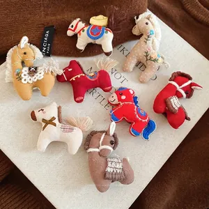 Assorted handmade fabric pony brooches with embroidery and rustic floral designs