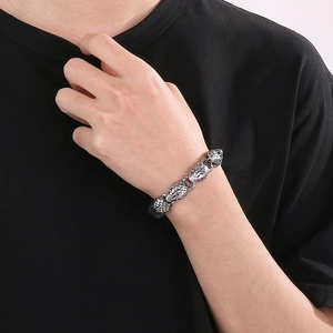 Macro detail of men's 15mm stainless steel snake head bracelet with vintage finish