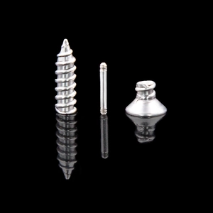 Macro shot of stainless steel screw earrings components with thread details and reflection