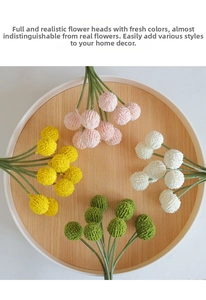 Top view of faux Billy Balls in multiple colors on a wooden tray for home decor