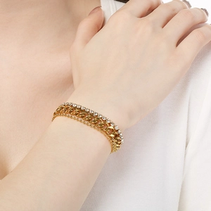 Close-up of three-layer gold bracelet set featuring cuban, bead, and tennis chain styles
