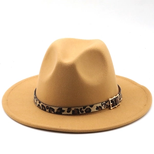 Close-up of leopard print belt and gold buckle on a wide brim camel fedora hat