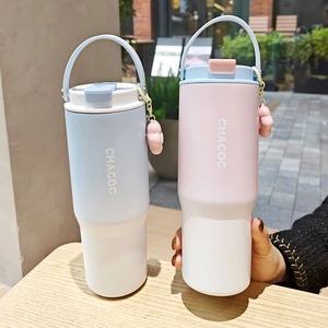Detail of vacuum insulated tumblers with portable handles and floral charms in pastel colors