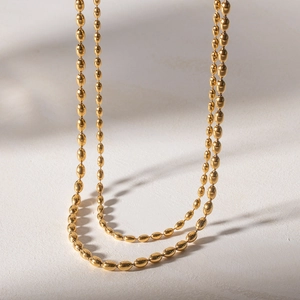 Double-layered gold stainless steel necklace with oval bead chain in a minimalist hip hop style