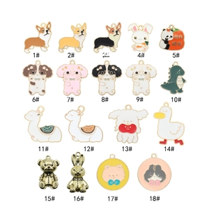 Close-up of assorted enamel cartoon charms featuring dogs and alpacas for DIY jewelry