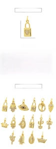 Macro view of 18K gold plated charms including Evil Eye and Heart with zircon stones