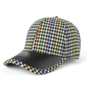 Fashionable baseball cap featuring colorful plaid tweed fabric and black leather brim