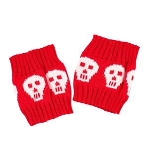 Detail of red knitted leg warmers featuring white skull patterns for a punk style look