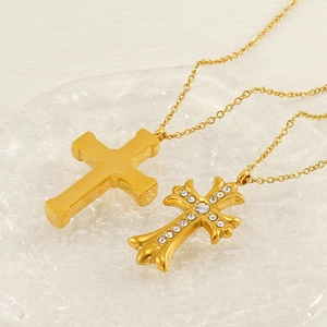 Minimalist and vintage gold stainless steel cross pendant necklaces set on crystal tray