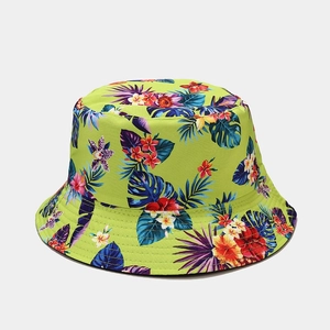Detailed close-up of tropical floral print on twill cotton sun hat in green