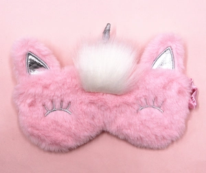 Close-up of pink unicorn sleep mask with soft plush fabric and silver horn detail