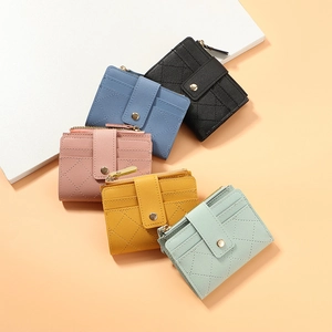 Close-up of quilted PU leather wallets in various colors with gold zipper detail