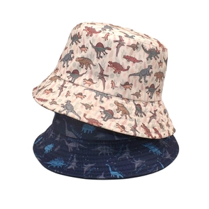 Reversible cartoon dinosaur sun bucket hat for men and women in beige and navy cotton
