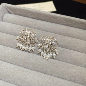 Macro view of fireworks design pearl ear clips featuring sparkling cubic zirconia stones