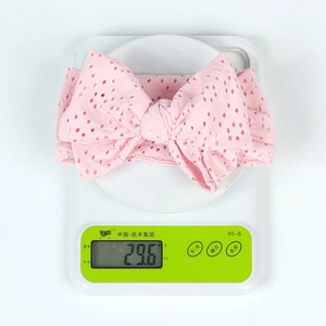 Pink eyelet embroidery baby headband with large bow weighing approximately 29.6g