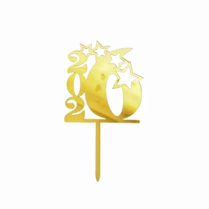 Detail of gold 2026 acrylic cake topper with star designs for New Year party decor