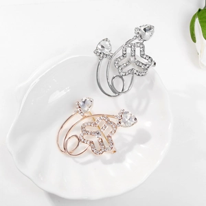 Women's Federation rhinestone brooches in silver and rose gold displayed on a white tray