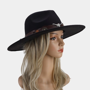 Close-up of black wool fedora with brown leather band and silver bull head metal ornament