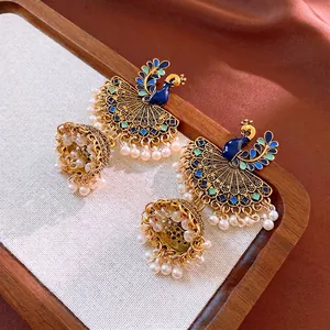 Vintage peacock tassel earrings with blue enamel finish and white pearl bell ornaments