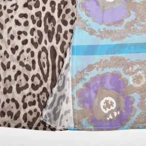 Detail view of chiffon dress fabric showing leopard print and baroque patterns stitching