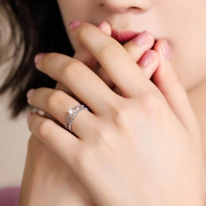 Elegant double-layered silver lace ring with sparkling zircon stone on a model's hand