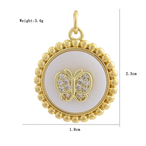Detail of a gold-plated charm featuring a white shell inlay and zircon butterfly