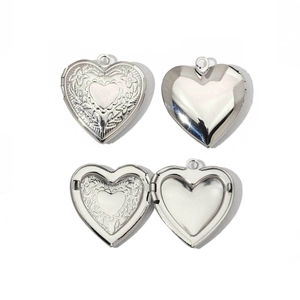 Detailed views of silver heart locket showing vintage floral engraving and mirror finish