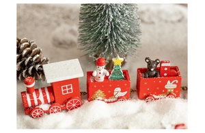 Macro detail of red wooden Christmas train with snowflake patterns and snowman figures