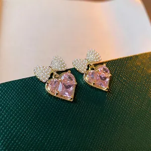 Pink heart zircon earrings with pearl bow detail and gold plating for women