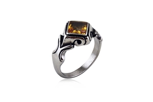 Macro view of vintage stainless steel ring featuring a square amber gemstone inlay