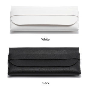 Close-up of textured white and black leather eyewear pouches with strap closure