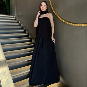 Detailed view of back lace-up closure on elegant black strapless floor-length maxi dress