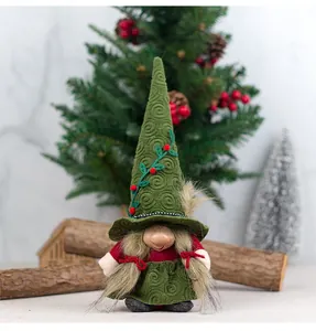 Close-up of a Christmas gnome doll with green pointed hat and gold pigtails in festive decor