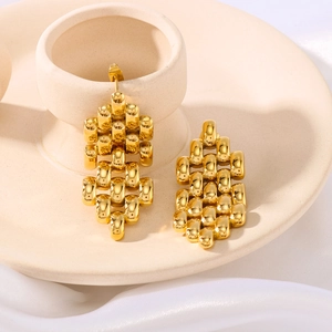 Fashion geometric stainless steel drop earrings with hollow woven chain design on beige tray