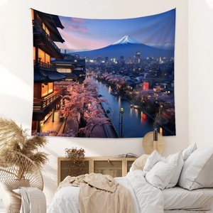 Detail view of a Fuji mountain night scene tapestry hung above a minimalist white bed