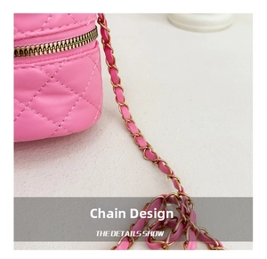 Detail of pink quilted leather bag featuring a gold chain strap with leather threading