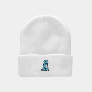 Detailed view of white ribbed knit beanie featuring blue dinosaur embroidery on the cuff