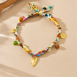 Bohemian choker featuring colorful floral fabric with gold heart and coin pendants