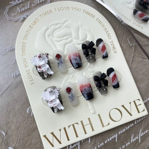 Handmade press-on nails with 3D angel relief, red rose art, and black bows with pearls