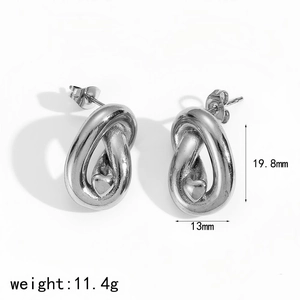 Macro shot of silver knotted heart stud earrings with size dimensions 19.8mm and 13mm