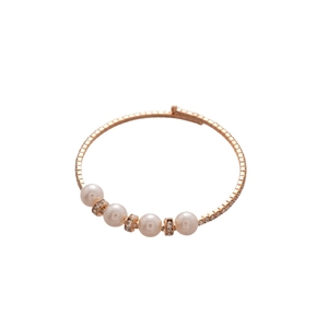 Rose gold layered spiral bracelet with pearls and pave zircons on white background